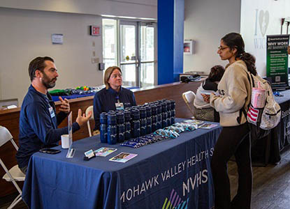 Hartwick student talking with potential employers during Industry Day
