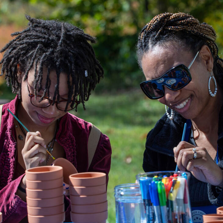 Hartwick student with family at Pine Lake crafting event
