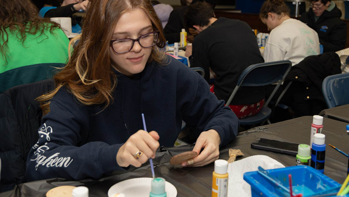Hartwick College student at Wick Express Event at crafting table
