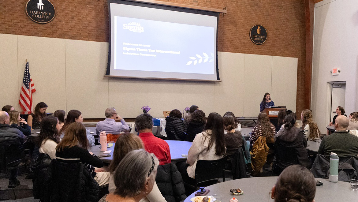 Omicron Rho chapter of the Sigma Theta Tau International Honor Society of Nursing President Maggie Van Valkenburgh ’26 speaking during induction ceremony