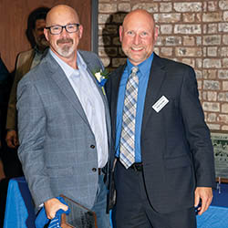 Hall of Famer Ken Ford ’94 shares a moment with Executive Director of Athletics Paul Vecchio at the 2025 Athletics Hall of Fame Induction Ceremony.