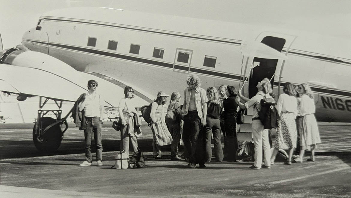 Hartwick College students during J Term alongside a plane in San Salvador