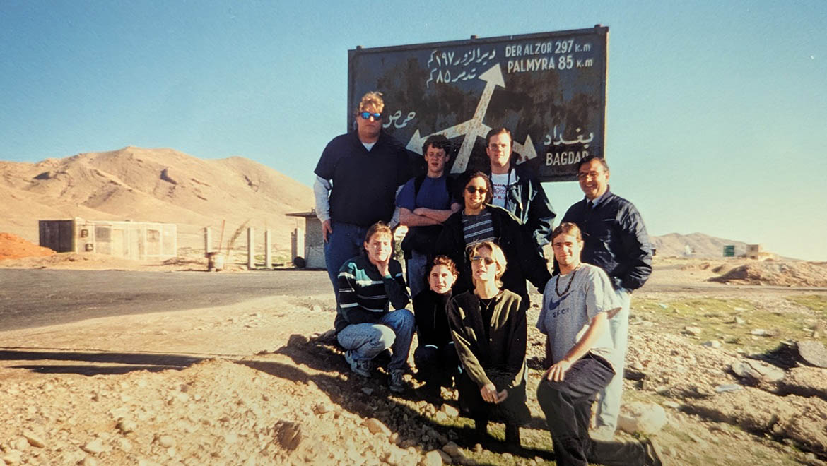 Hartwick College students during J Term at road sign in Syria