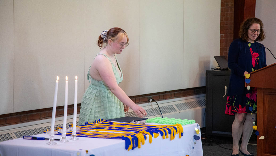 Hartwick College Eta Mu Chapter of Delta Alpha Pi academic honor society induction ceremony in Shineman Chapel House, ceremony table with candles, honor cords