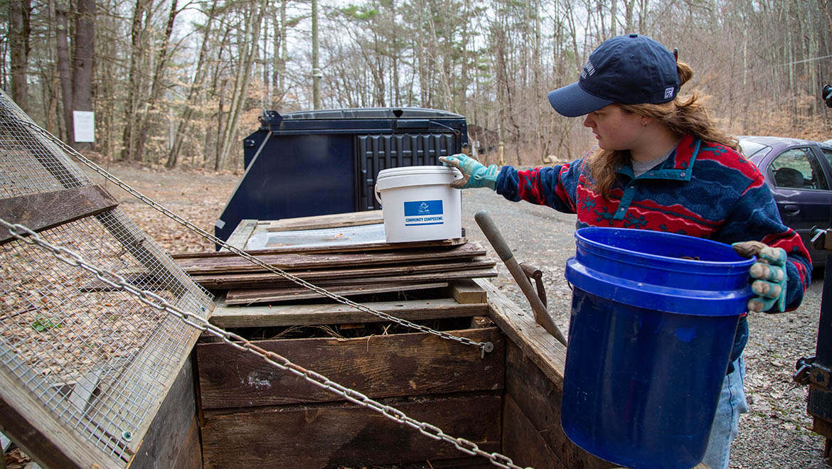 Abi DeMan ’26 at compost bin at Pine Lake with buckets
