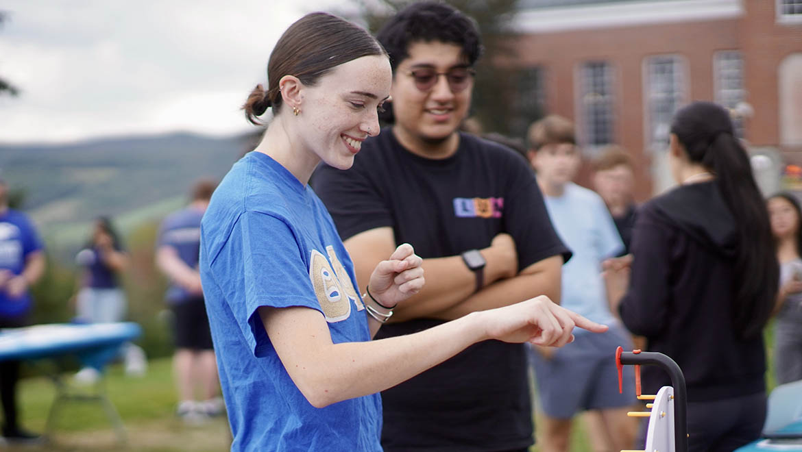 Hartwick College students playing game during Taste of Wick club fair on Frisbee Field
