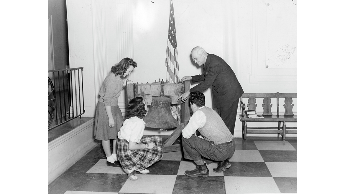 Hartwick College President Arnold with students and the Hartwick Bell