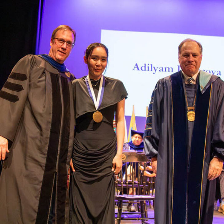 John Christopher Hartwick Scholar Adilyam Imyarova with Professor Buthman and President Mullen