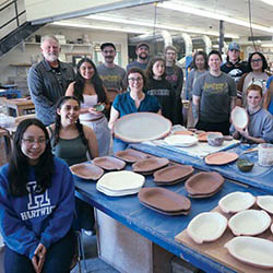 Hartwick ceramics students, Professor Stephanie Rozene and Oneonta’s Autumn Café team in ceramics studio with dinnerware