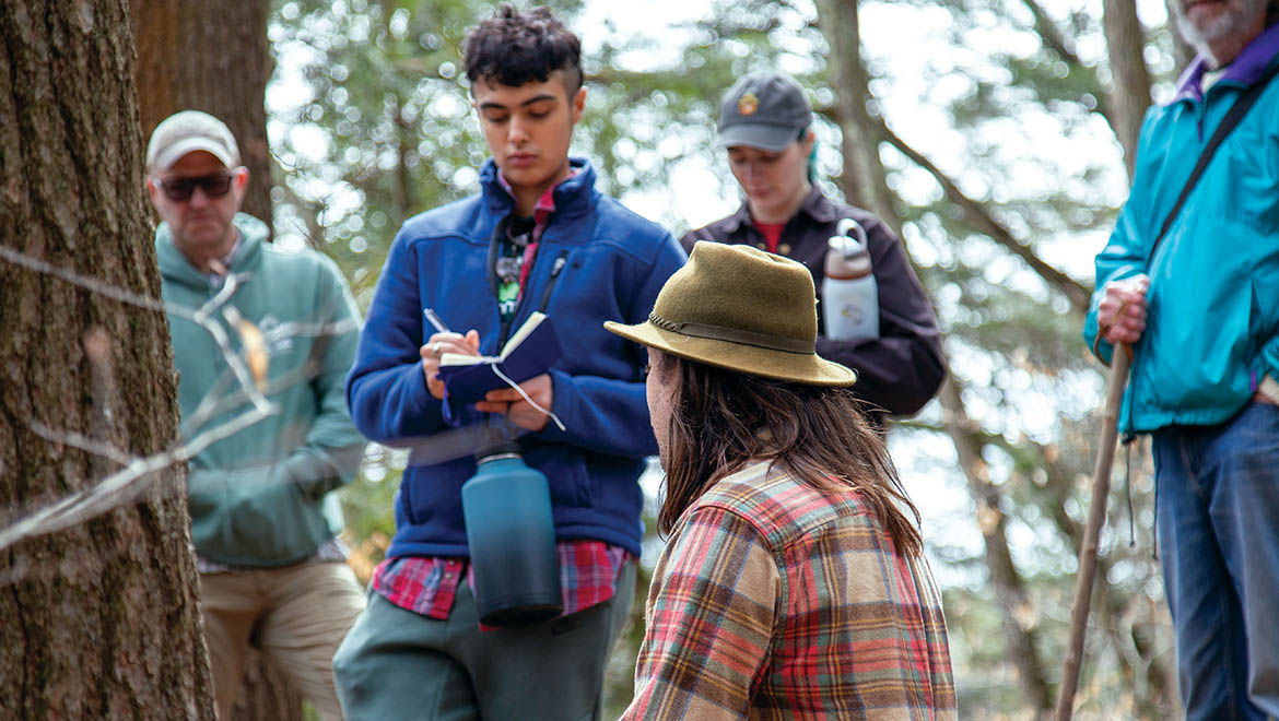 Meer Singh ’26 takes notes as Justin Wexler of Wild Hudson Valley shares the indigenous history of Pine Lake earlier this spring.