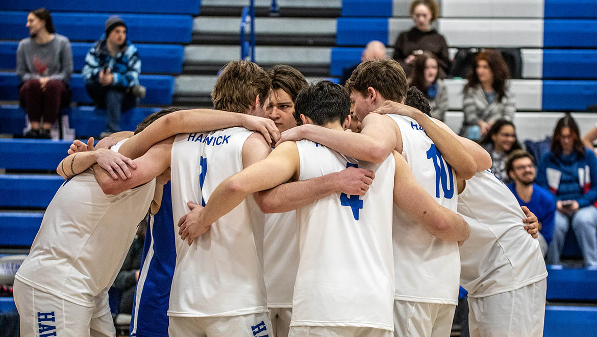 Hartwick men's volleyball team in huddle during a match in Lambros Arena