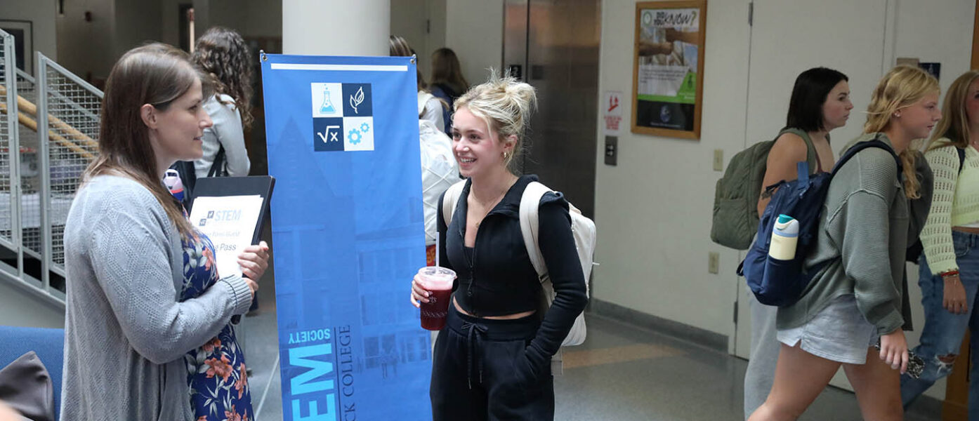Hartwick College faculty member talking with student in Johnstone Science Center