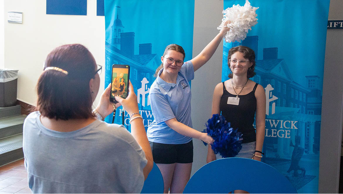 Hartwick College new student posing for photo with family during Summer Orientation