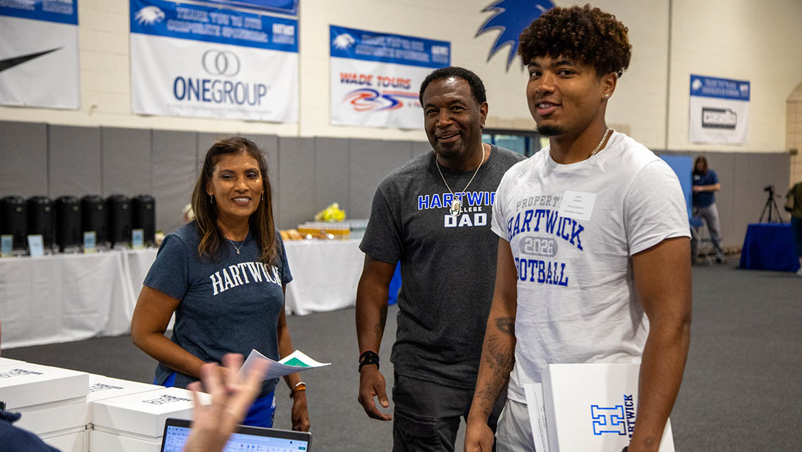 Hartwick College new student with family at Summer Orientation in Lambros Arena