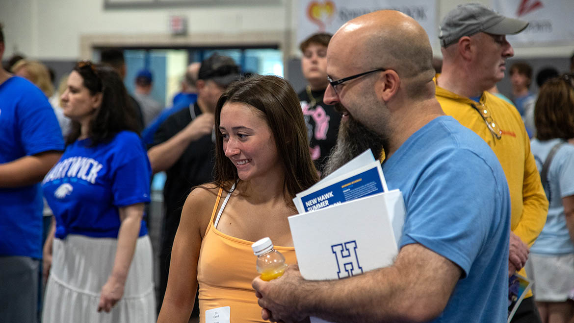 Hartwick College new student with family at Summer Orientation in Lambros Arena
