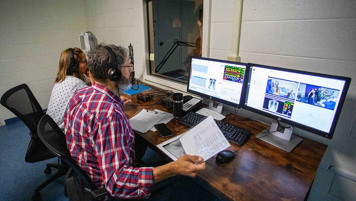 Dr. Russell Moore, internal medicine program director at Bassett Healthcare Network, viewing monitors during patient care simulation