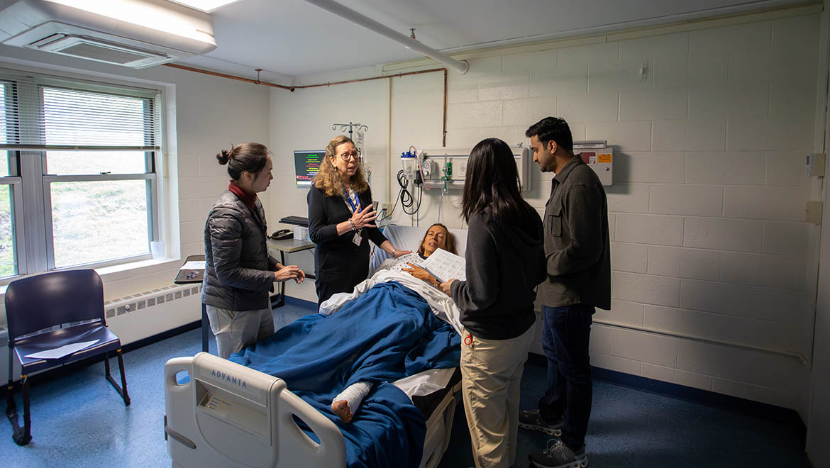 Bassett Healthcare Network professionals and resident physicians attend to a patient in Brent R. Nicklas School of Nursing simulation lab