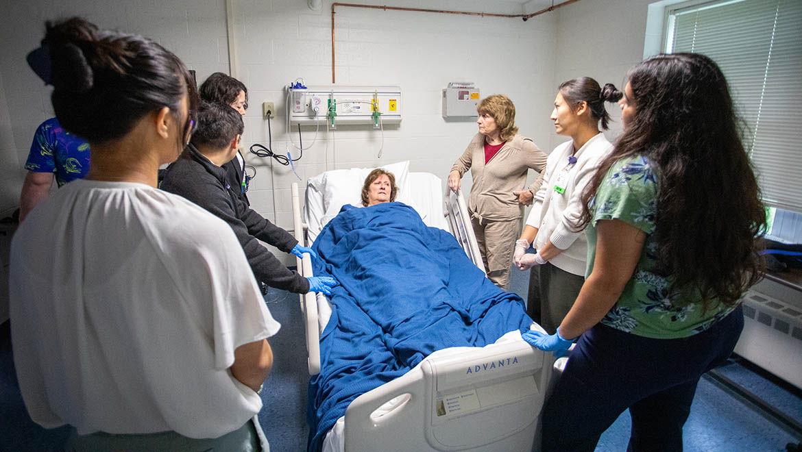 Bassett Healthcare Network professionals and resident physicians attend to a patient with Brent R. Nicklas School of Nursing faculty in the simulation lab