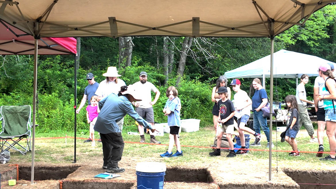 Children participating in Oneonta World of Learning (OWL) visiting Hartwick College’s Archaeological Field School archaeology excavation site at Pine Lake