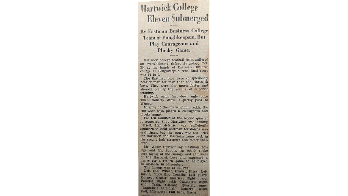 A vintage newspaper clipping titled 'Hartwick College Eleven Submerged' describing a football game where Hartwick lost 67-0 but played courageously.