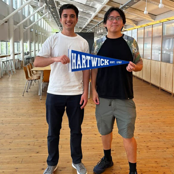 Sandro MakharashviliI and founder of Galari Inc./KYOTO Design Lab, Kyoto, Japan holding a blue Hartwick College pennant