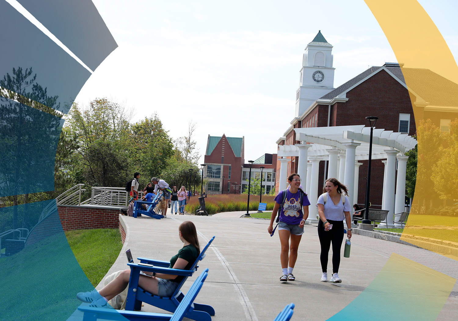 Hartwick students on a sunny college campus with brick buildings and a clock tower. A girl sits in a blue chair with a laptop, while two girls walk and smile. Other students and a dog are also visible.
