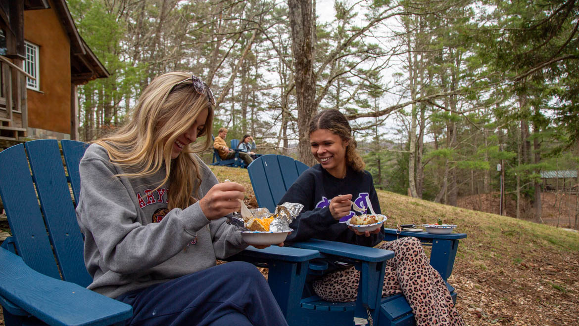 Hartwick College students eating outdoors at Pine Lake Thaw Fest