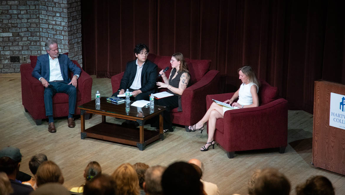 Panel discussion with Mike McIntire with audience in the foreground.