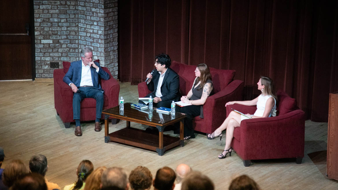 Panel discussion with Mike McIntire with audience in the foreground.
